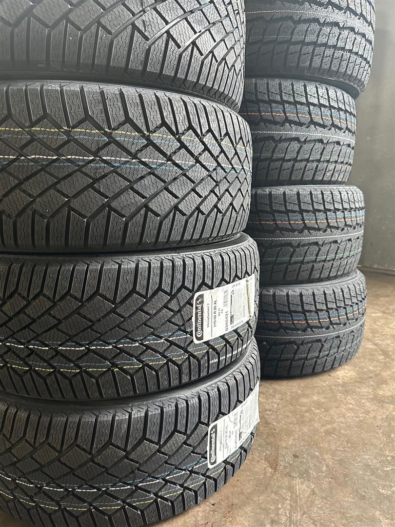 A bunch of tires are stacked on top of each other. | Lou's Car Care Center, Inc.