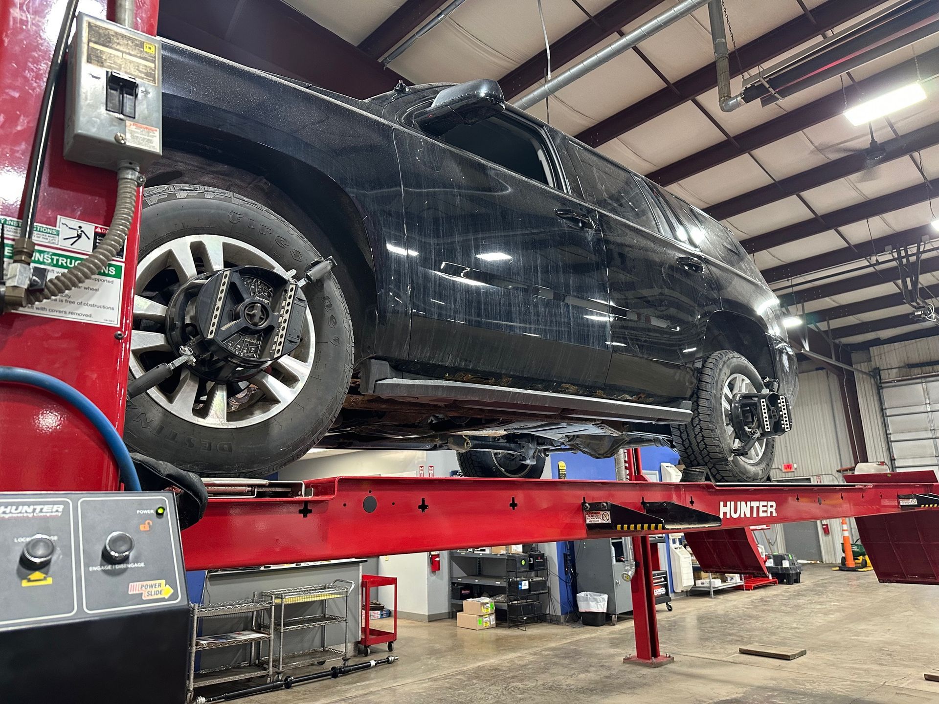 Black SUV on Hunter Alignment Rack