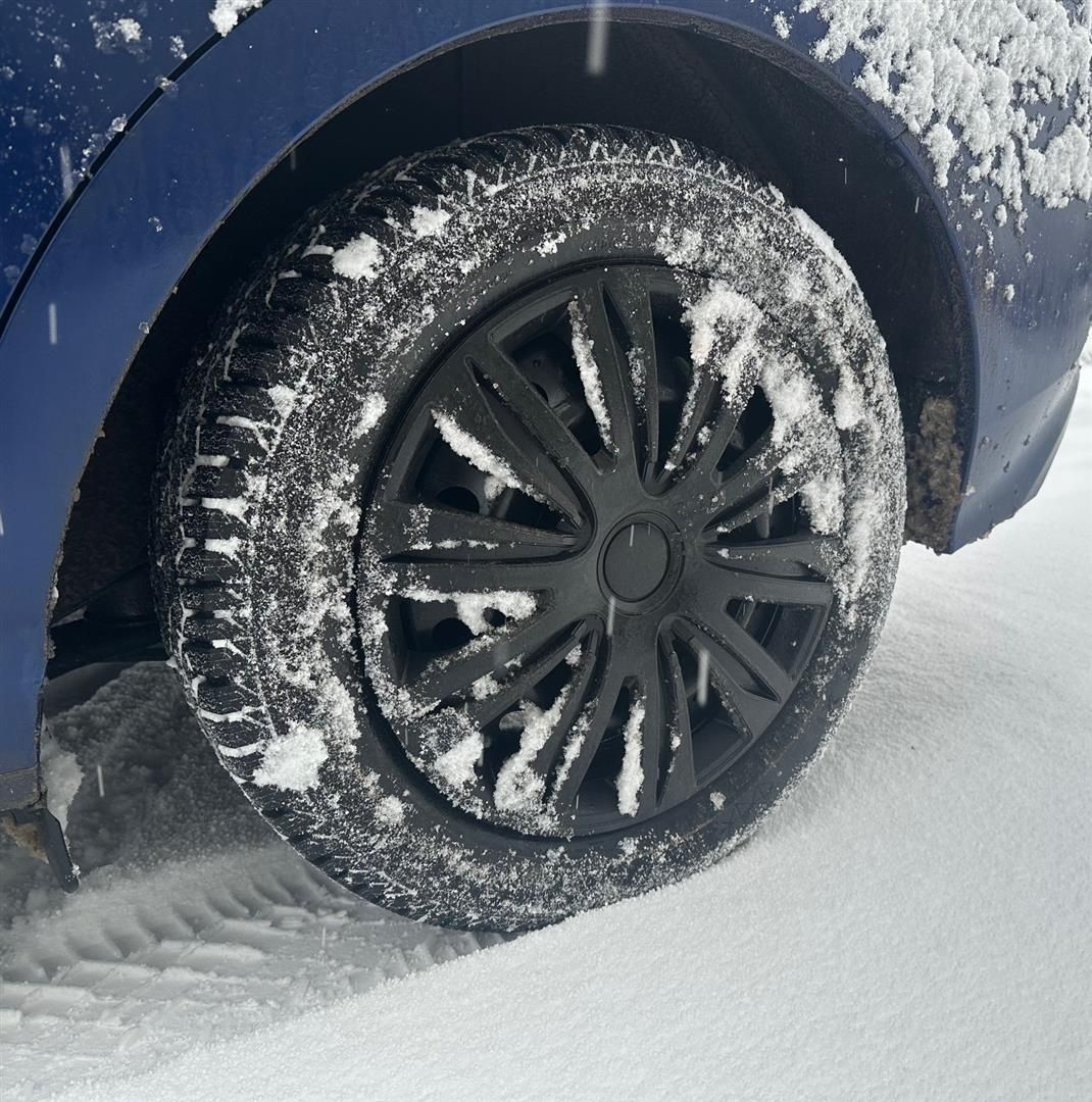 A close up of a car wheel with snow on it | Lou's Car Care Center