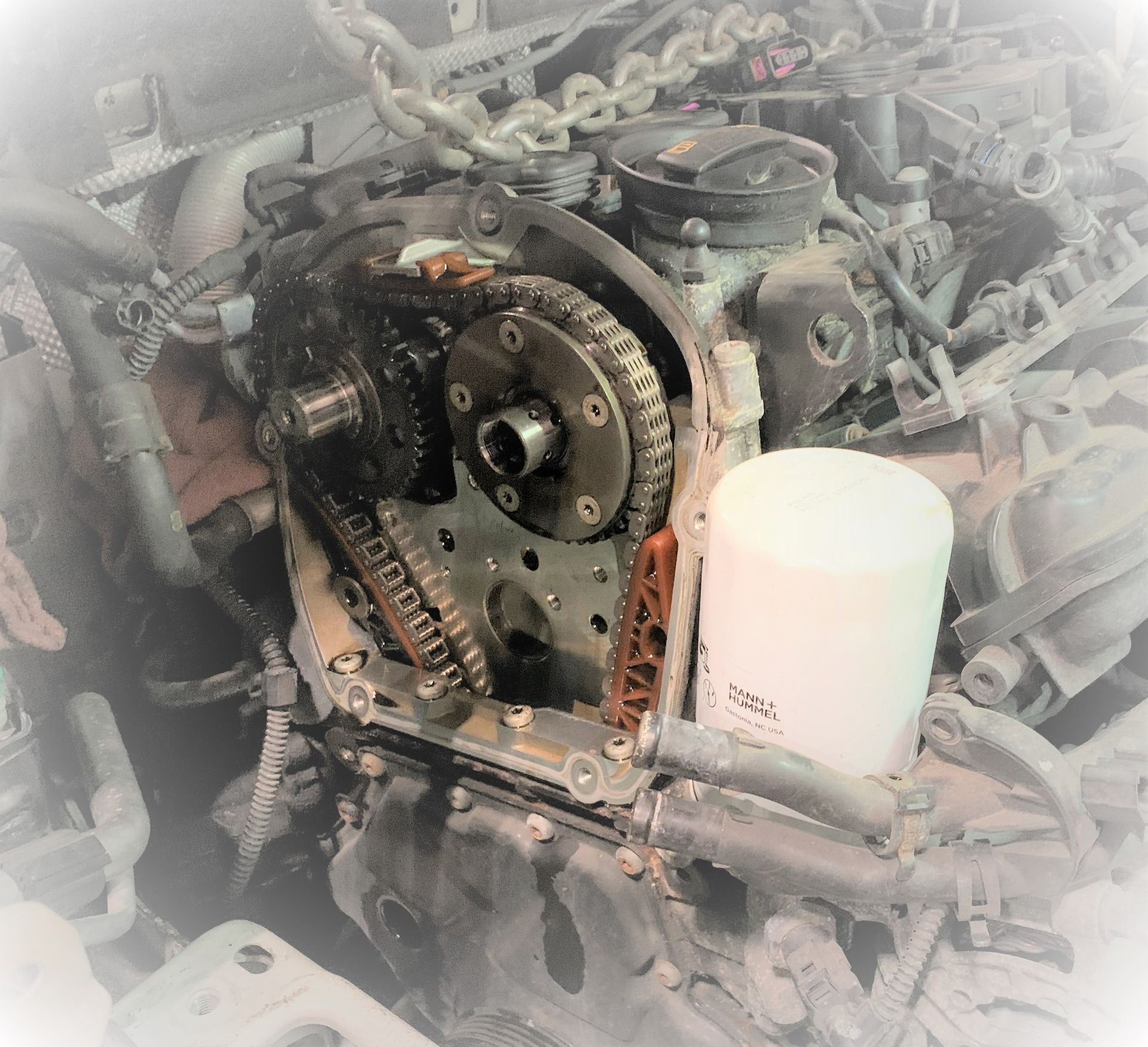 A close up of a car engine with a filter on it | | Lou's Car Care Center Inc.