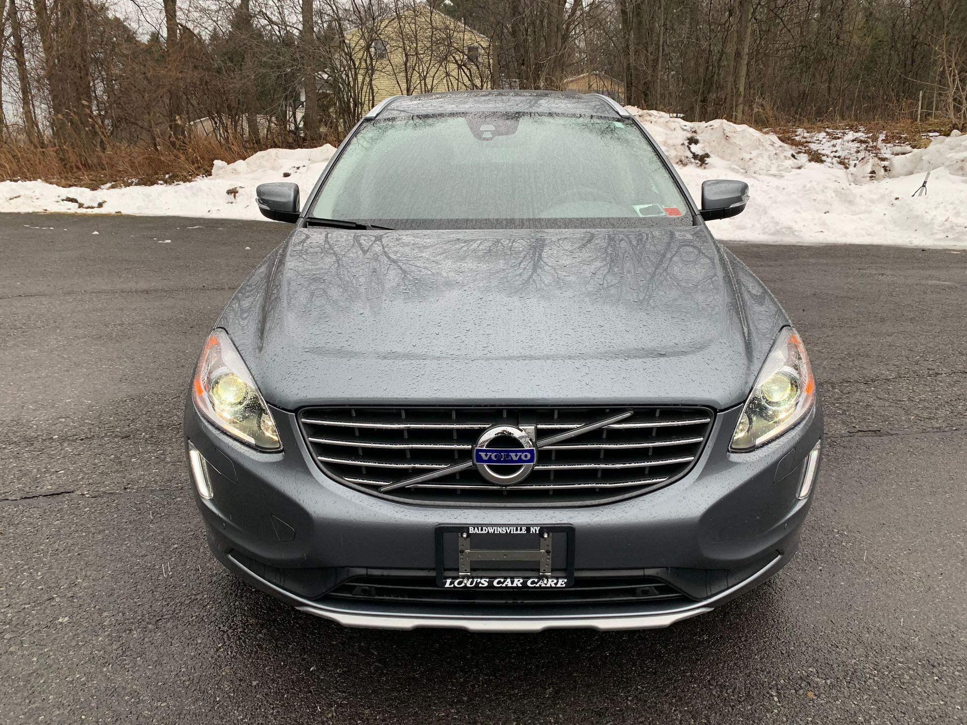 A volvo car is parked on the side of the road in the snow. | Lou's Car Care Center Inc.