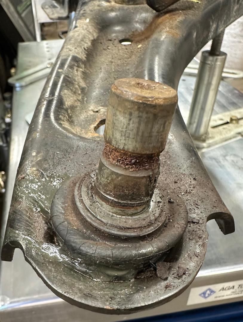 A close up of a rusty piece of metal on a table. | Lou's Car Care Center, Inc.