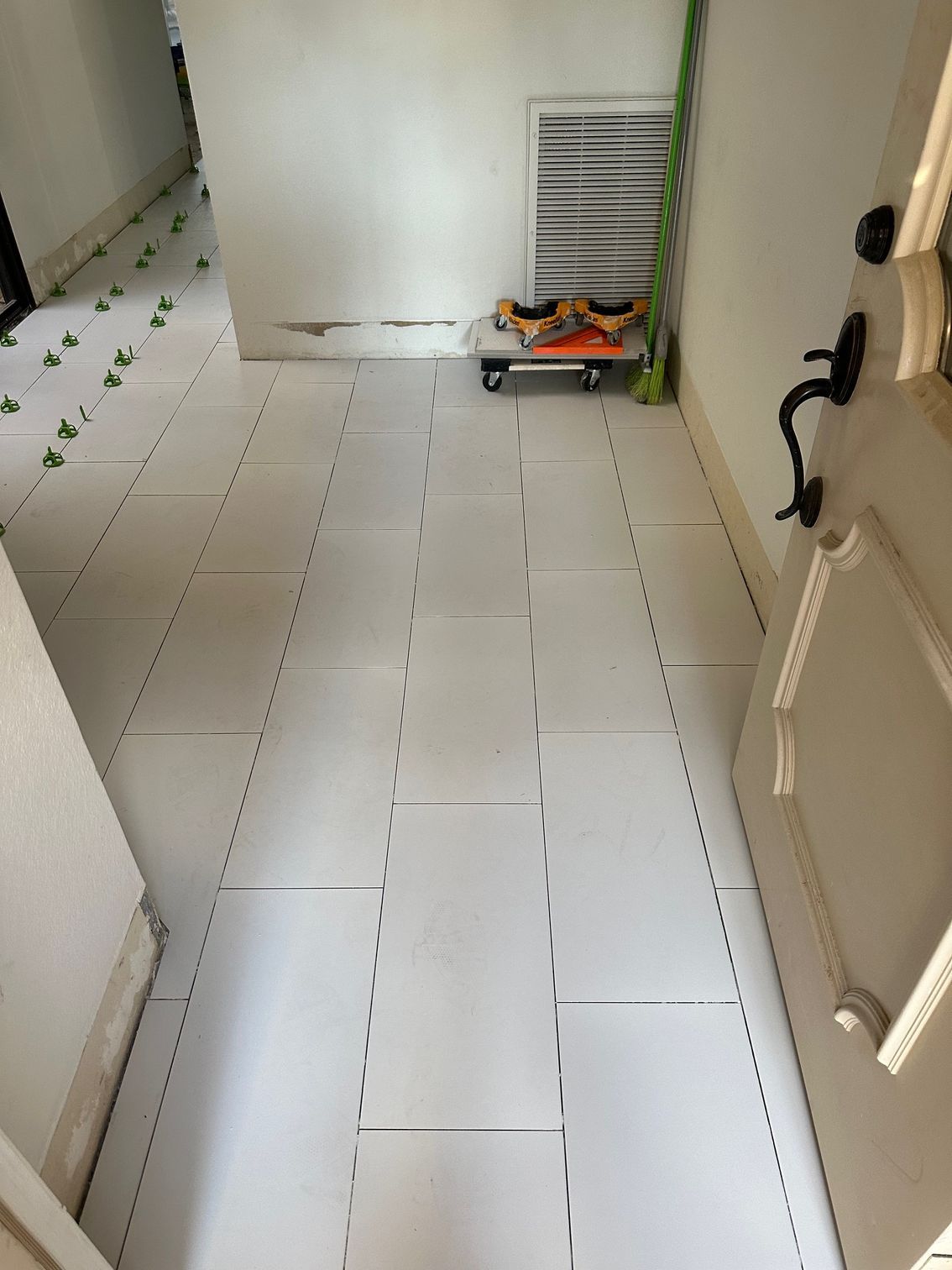 Hallway with white tiled floor