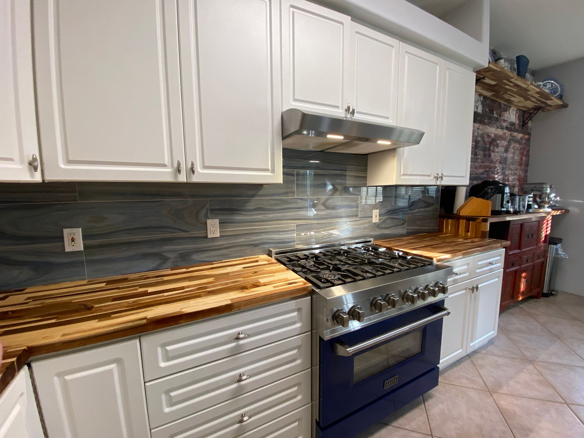 Modern white kitchen with stainless steel appliances