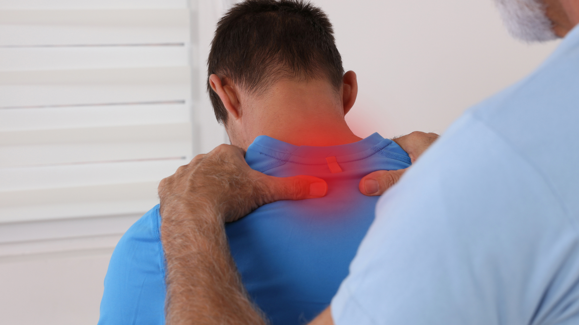 Man receiving neck massage from a therapist, with red pain highlight on the shoulders and neck