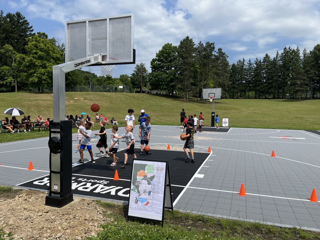 A group of children are playing basketball on a court.