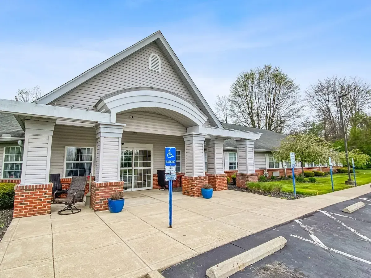 A large building with a handicapped parking sign in front of it.