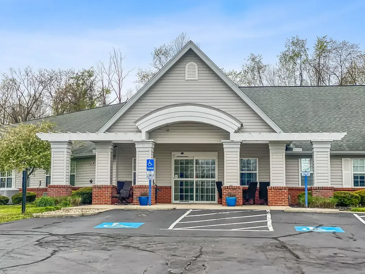 A large house with a handicapped parking spot in front of it