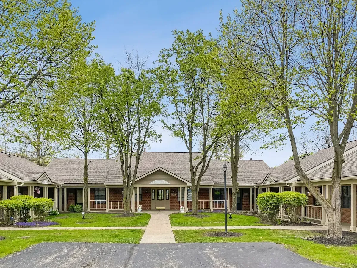 A large house with a lot of trees in front of it.