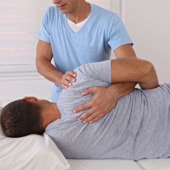 A man is receiving chiropractic adjustments