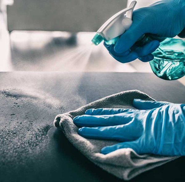 Professional Worker Sanitizing Surfaces