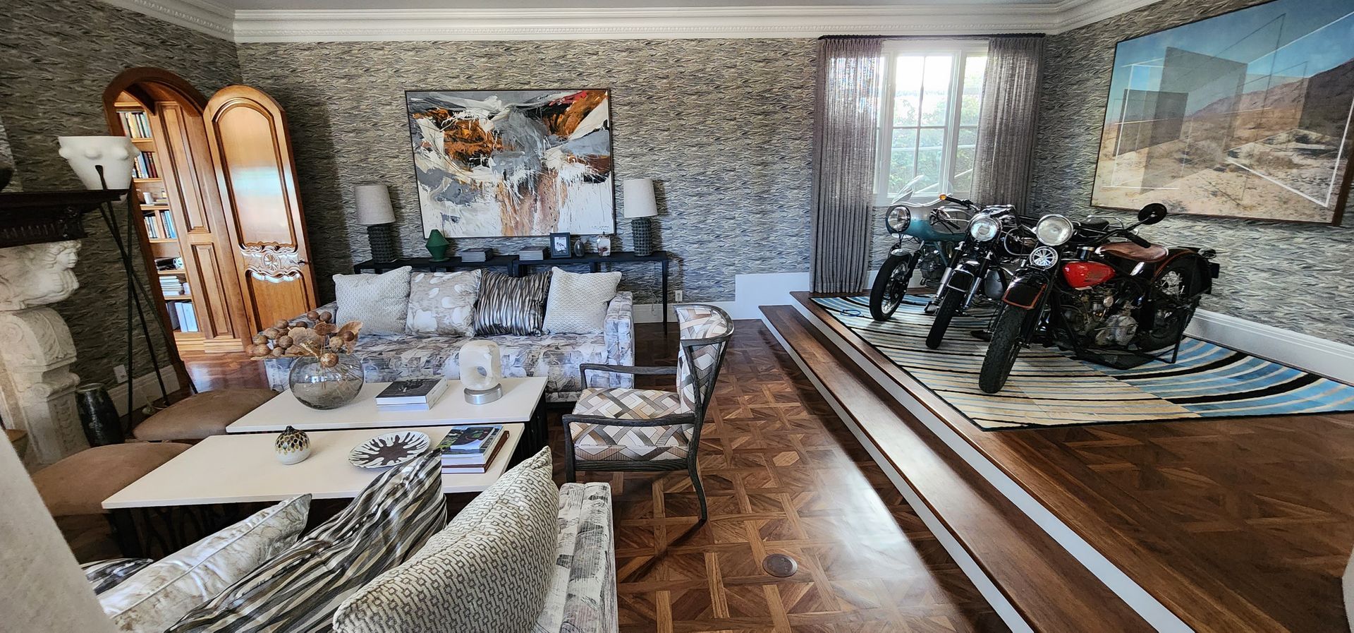 Living room with sofas, dining table, stone wall, and large painting, cluttered with tools and materials