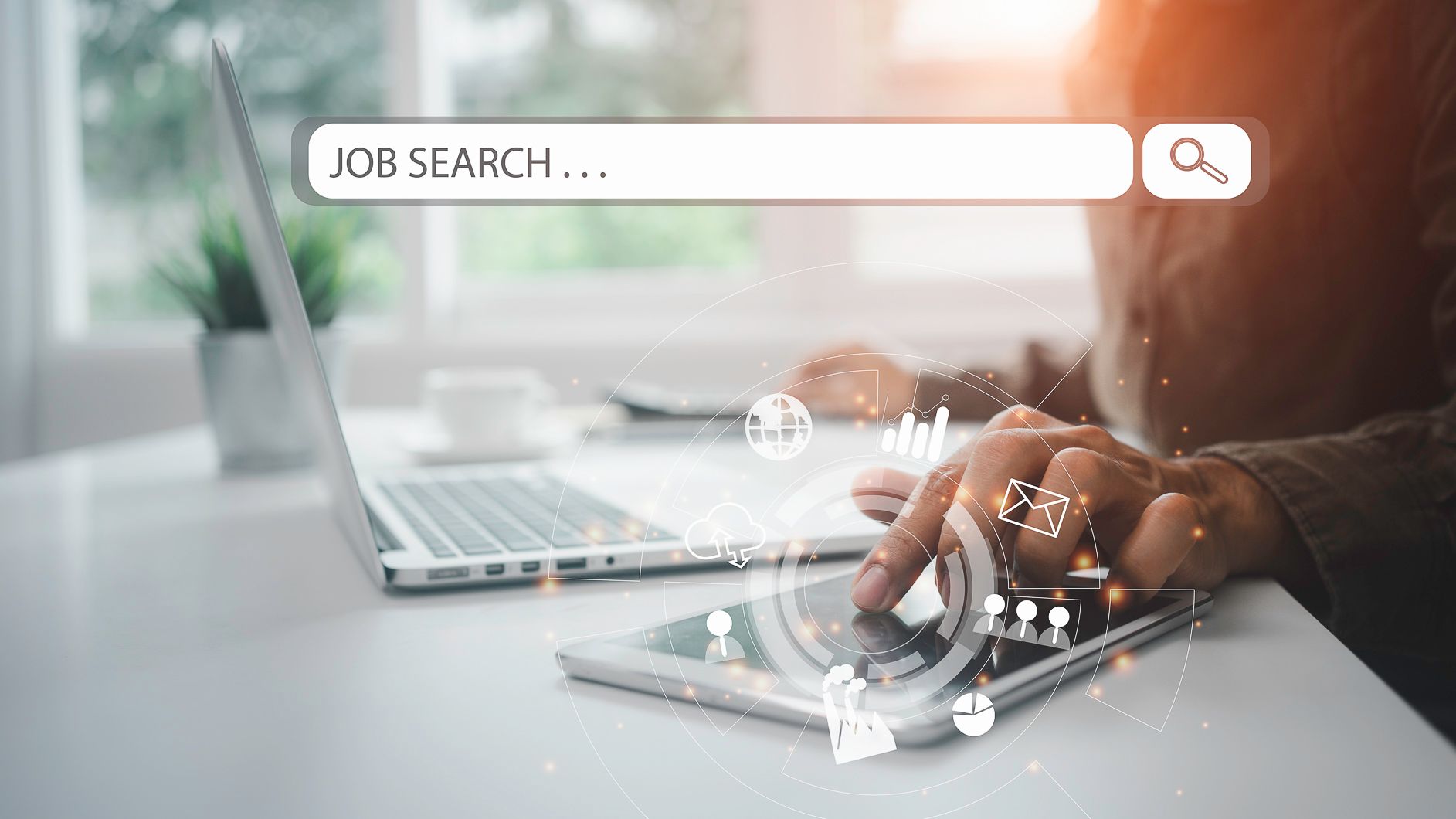 Person searching for jobs on a laptop and tablet, with a job search bar overlay.