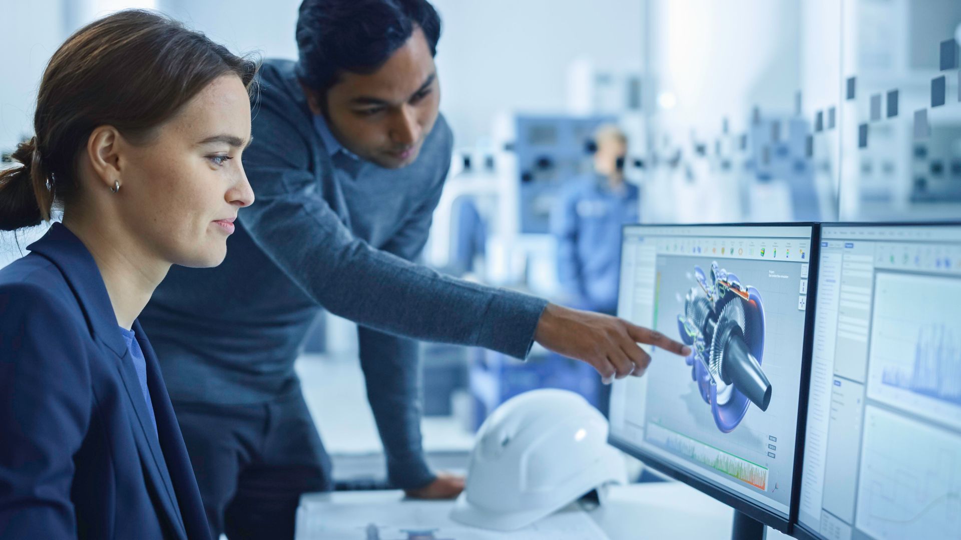 Two engineers at a screen