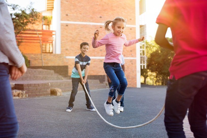 Children skipping in school grounds