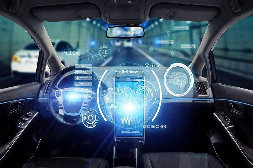Inside a self-driving car; dashboard with glowing blue data display; road ahead.
