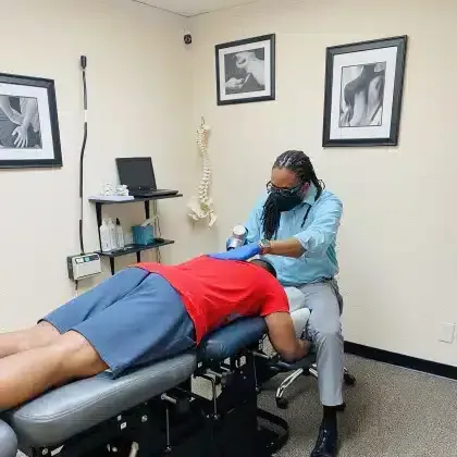 Patient receiving a chiropractic treatment on a table in a clinic room