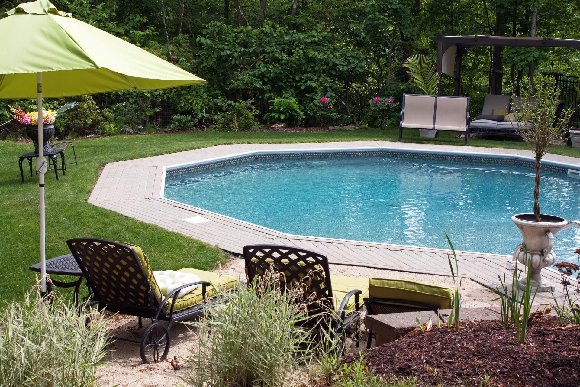 landscaped yard with pool or hot tub