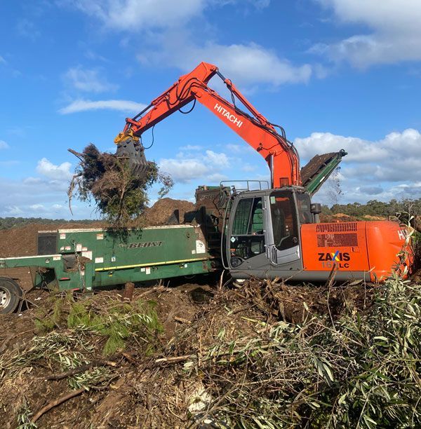 A hitachi excavator is digging in a field