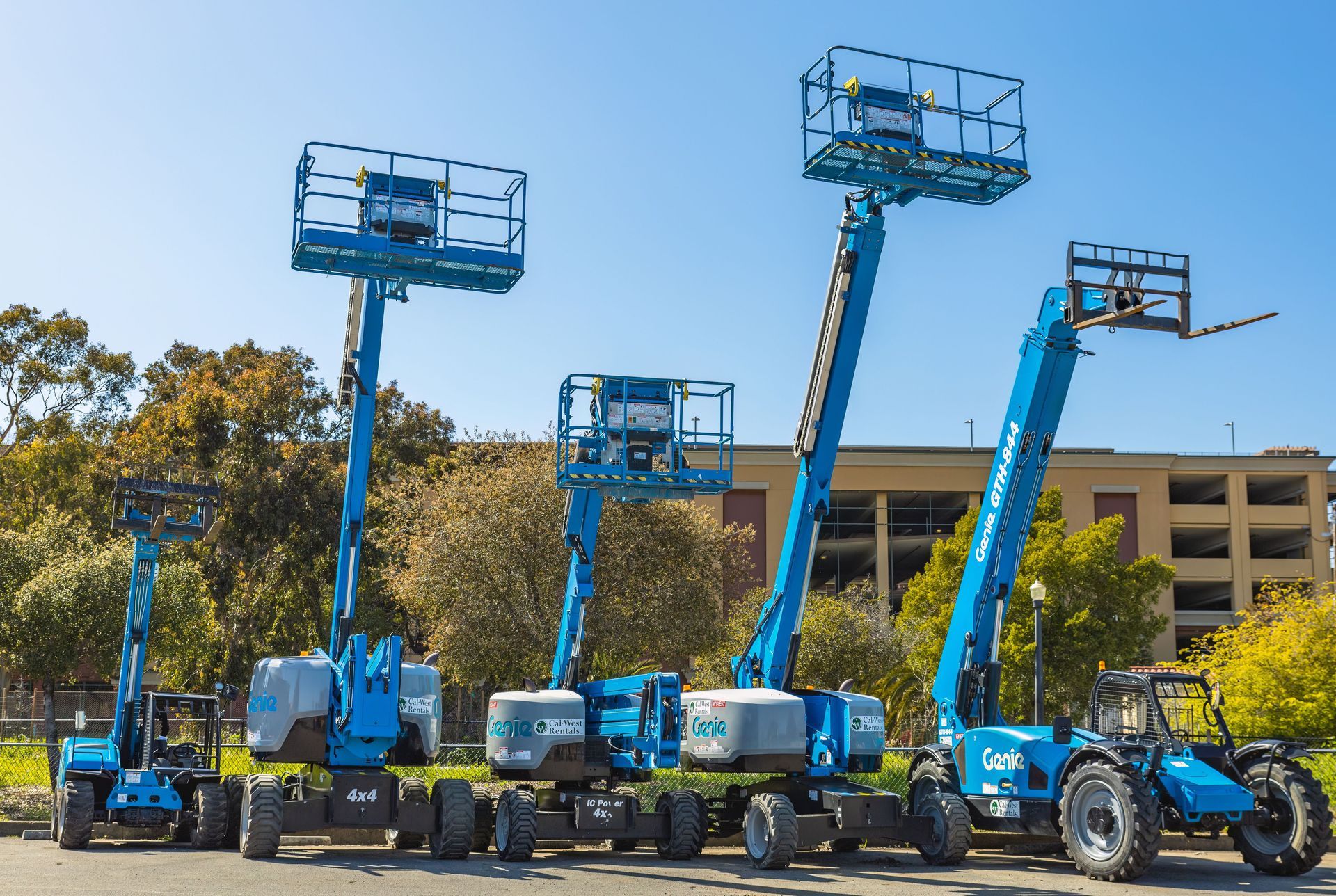 Blue boom lifts lined up