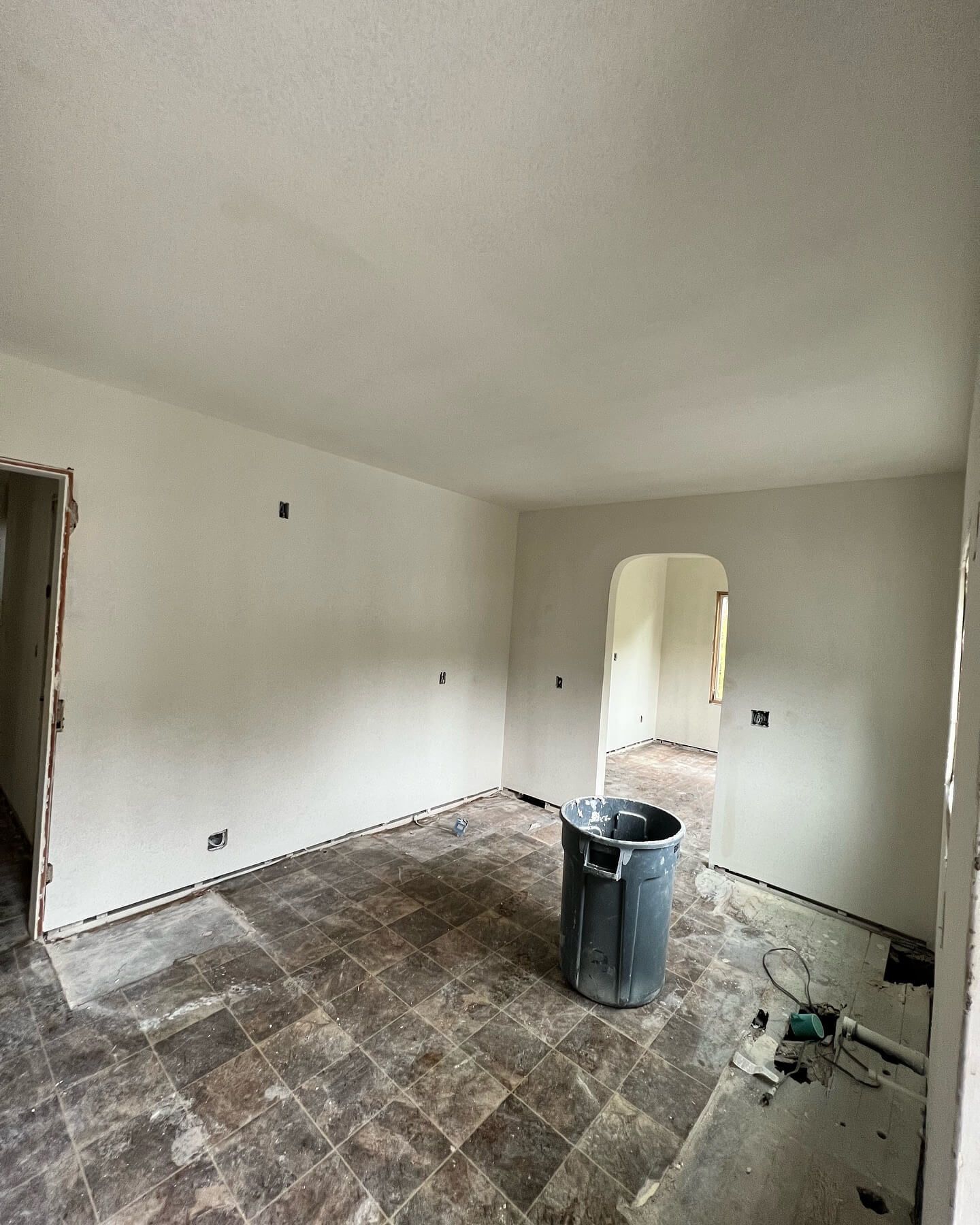 Room undergoing renovation with exposed flooring
