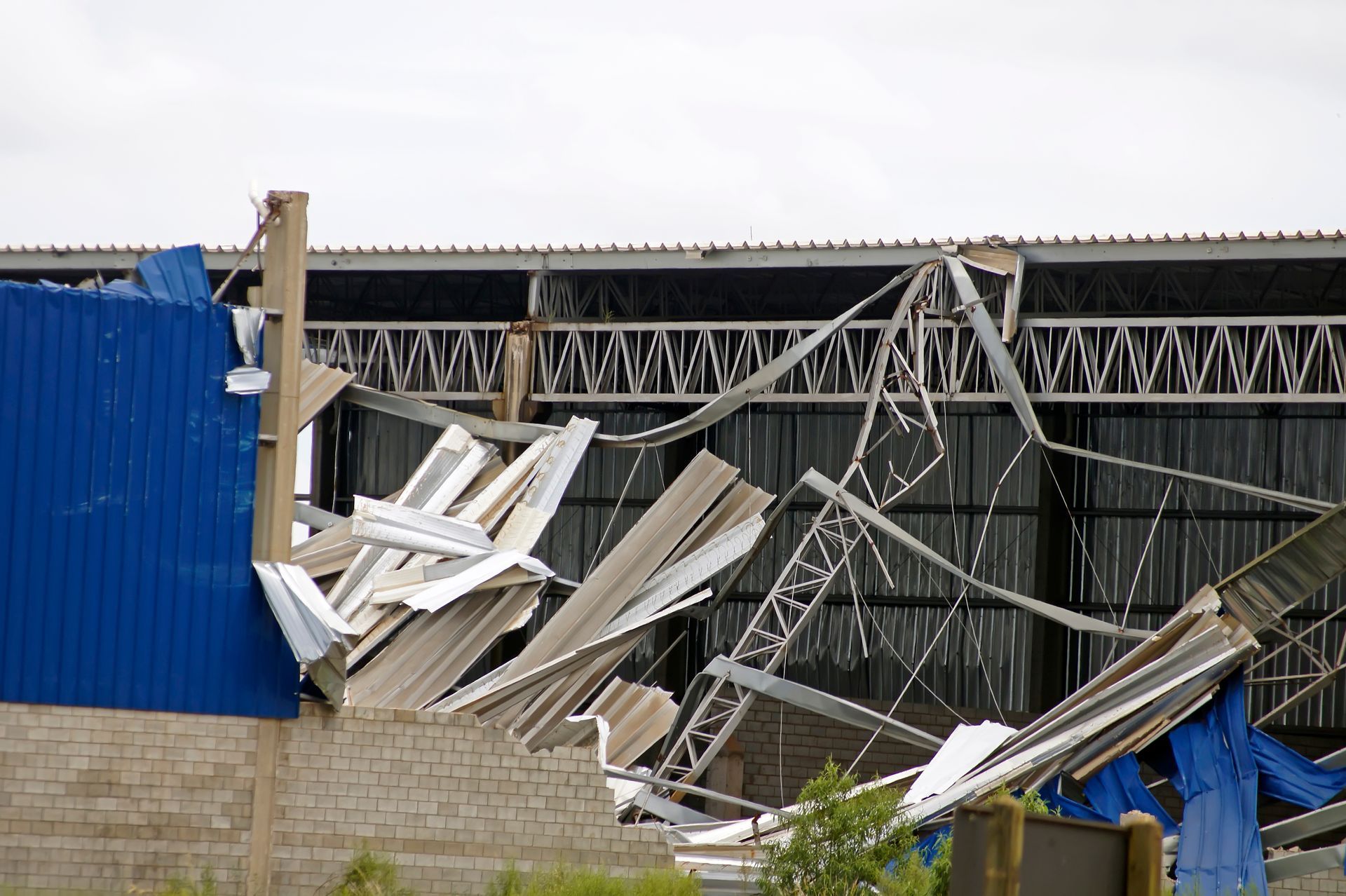 a roof of a building that has been damaged by a storm .