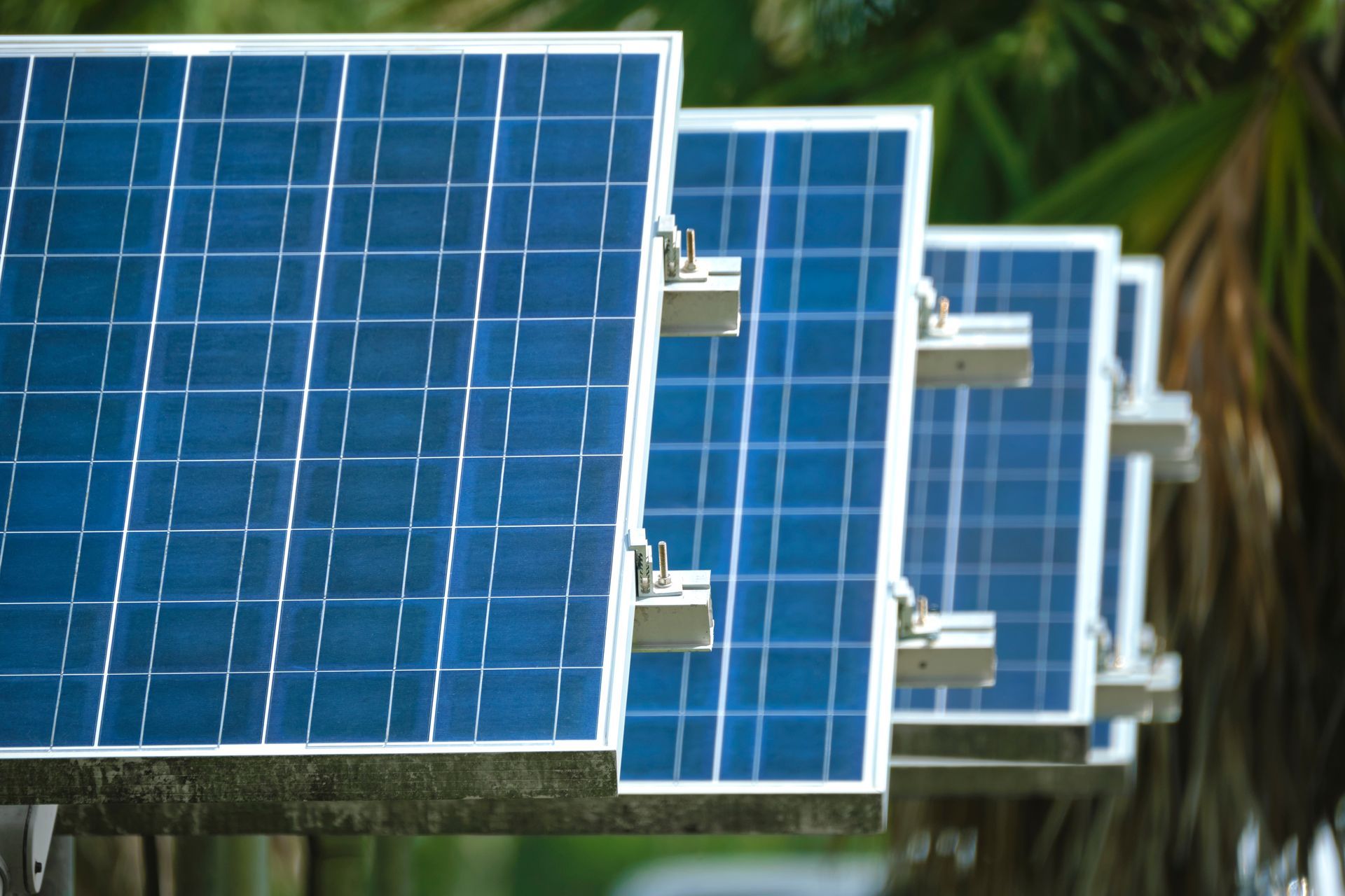 a row of solar panels sitting next to each other on a fence .