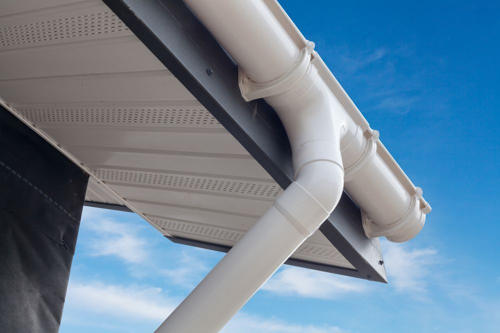 A White Gutter Is Attached To The Roof Of A House — Sattin's Metal Roofing In Kiama, NSW