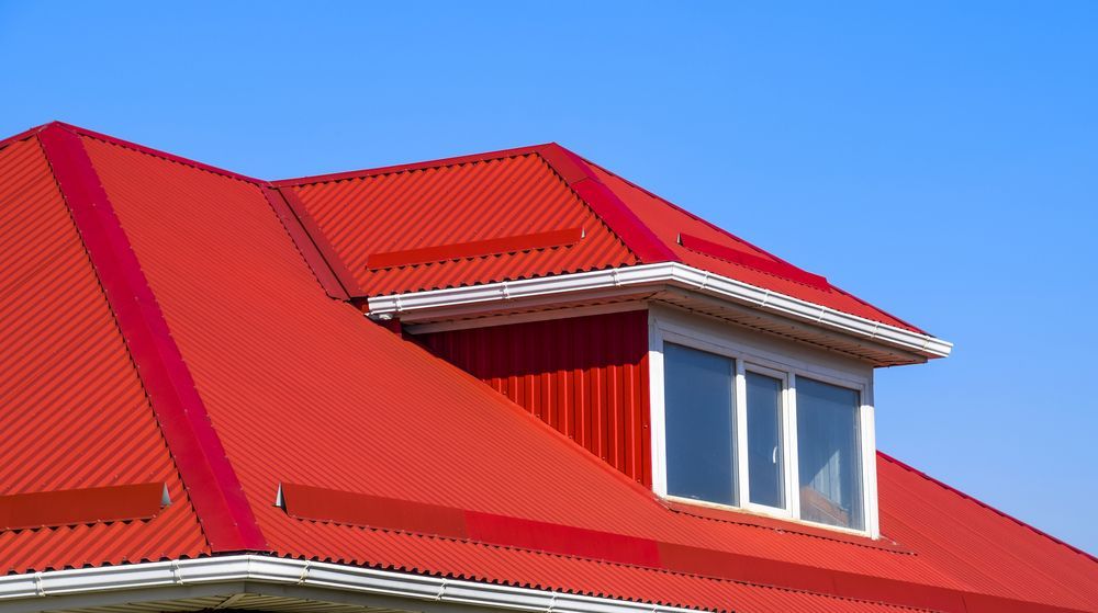 A Red Roof With A Window On Top Of It — Sattin's Metal Roofing In Kiama, NSW