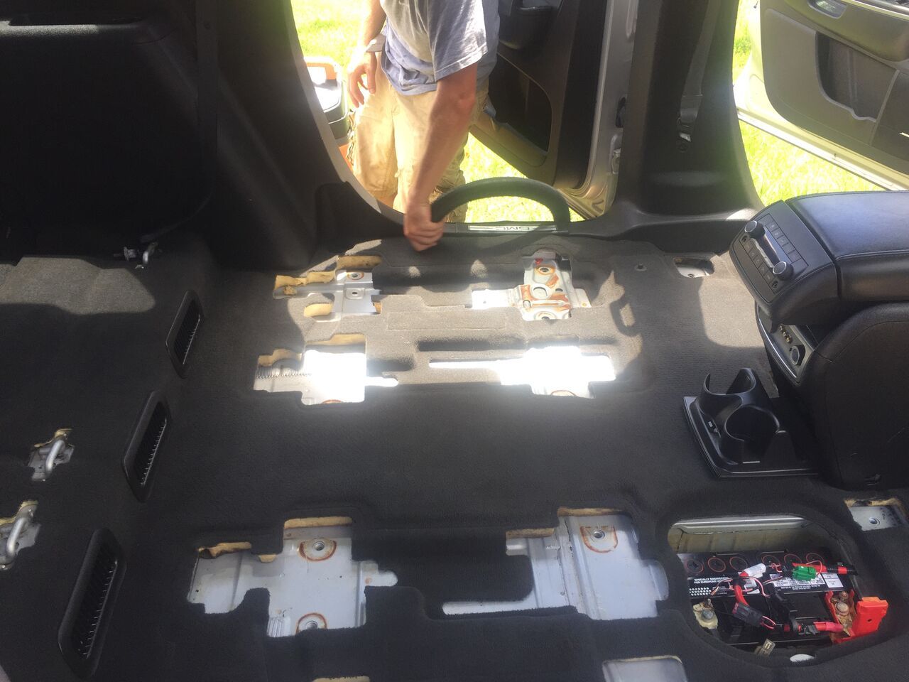 Vacuuming the car flooring and mat