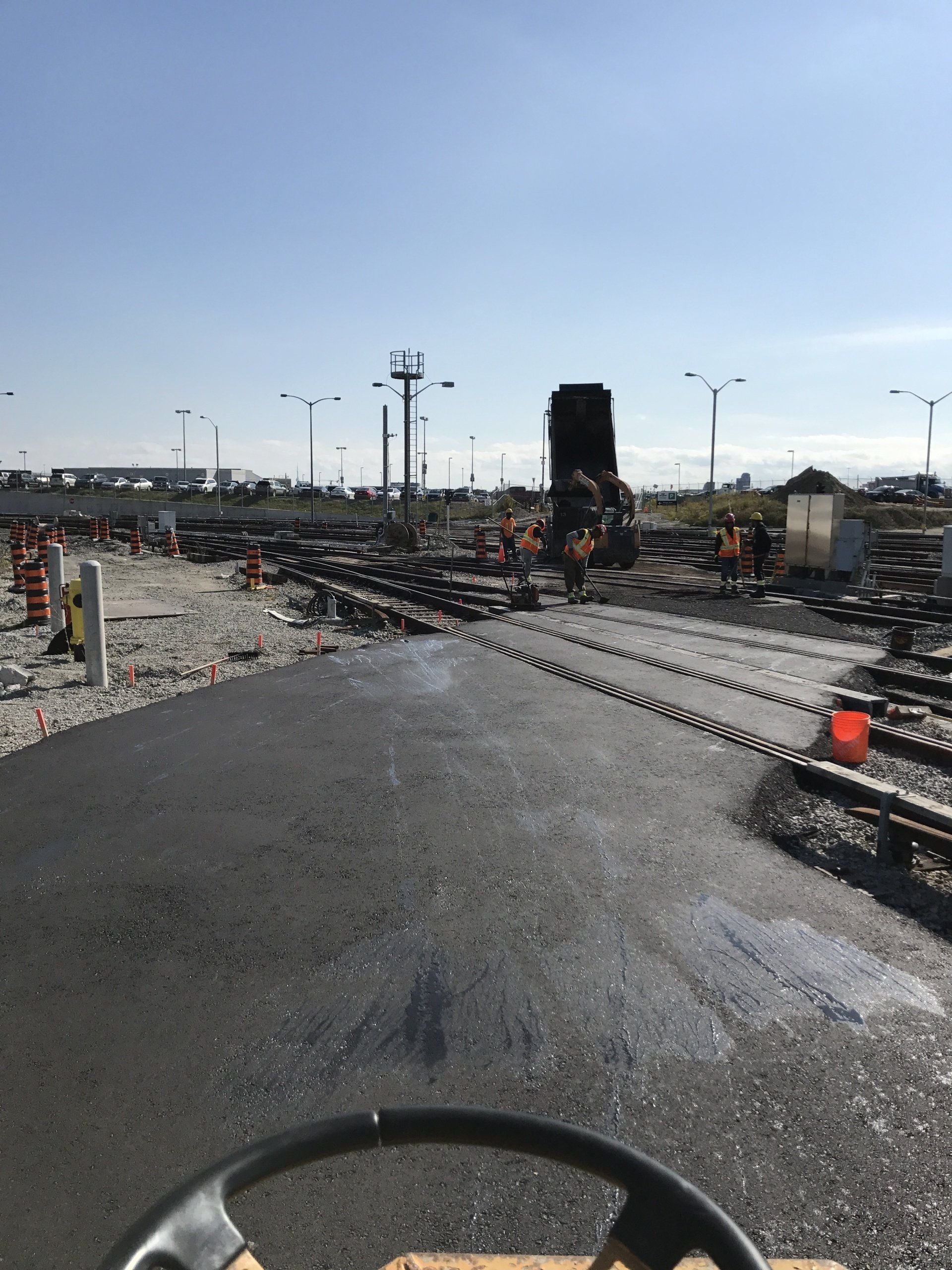 A construction site with a steering wheel in the foreground