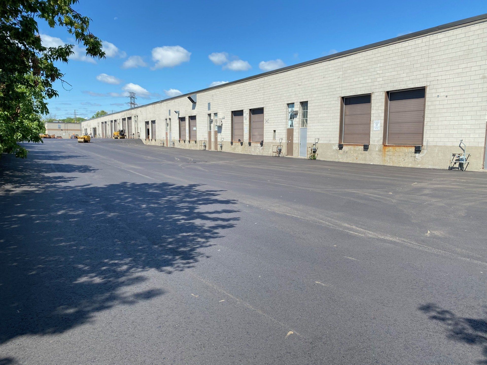 A row of warehouses with a lot of loading doors