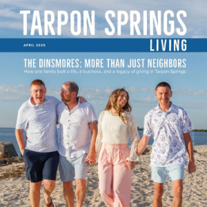 Four people walking on a beach under the Tarpon Springs Living magazine title