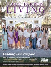 Tarpon Springs city magazine cover featuring three people, one speaking into a microphone in a street scene