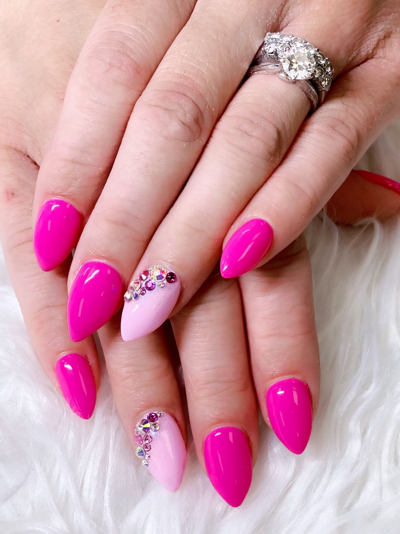 a woman with pink nails and a ring on her finger