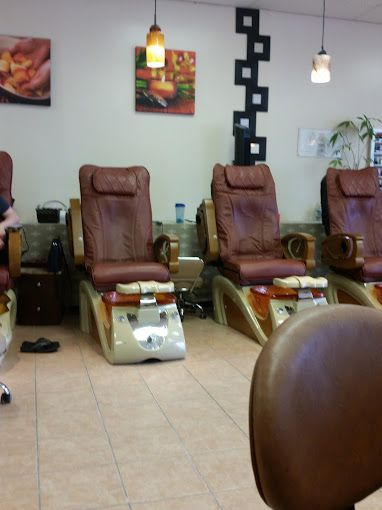 a man sits in a chair in a nail salon