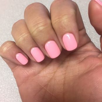 a close up of a person 's hand with pink nails .