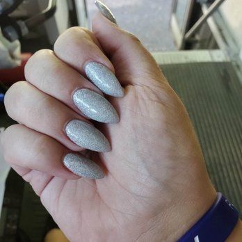 a close up of a person 's hand with long gray nails .