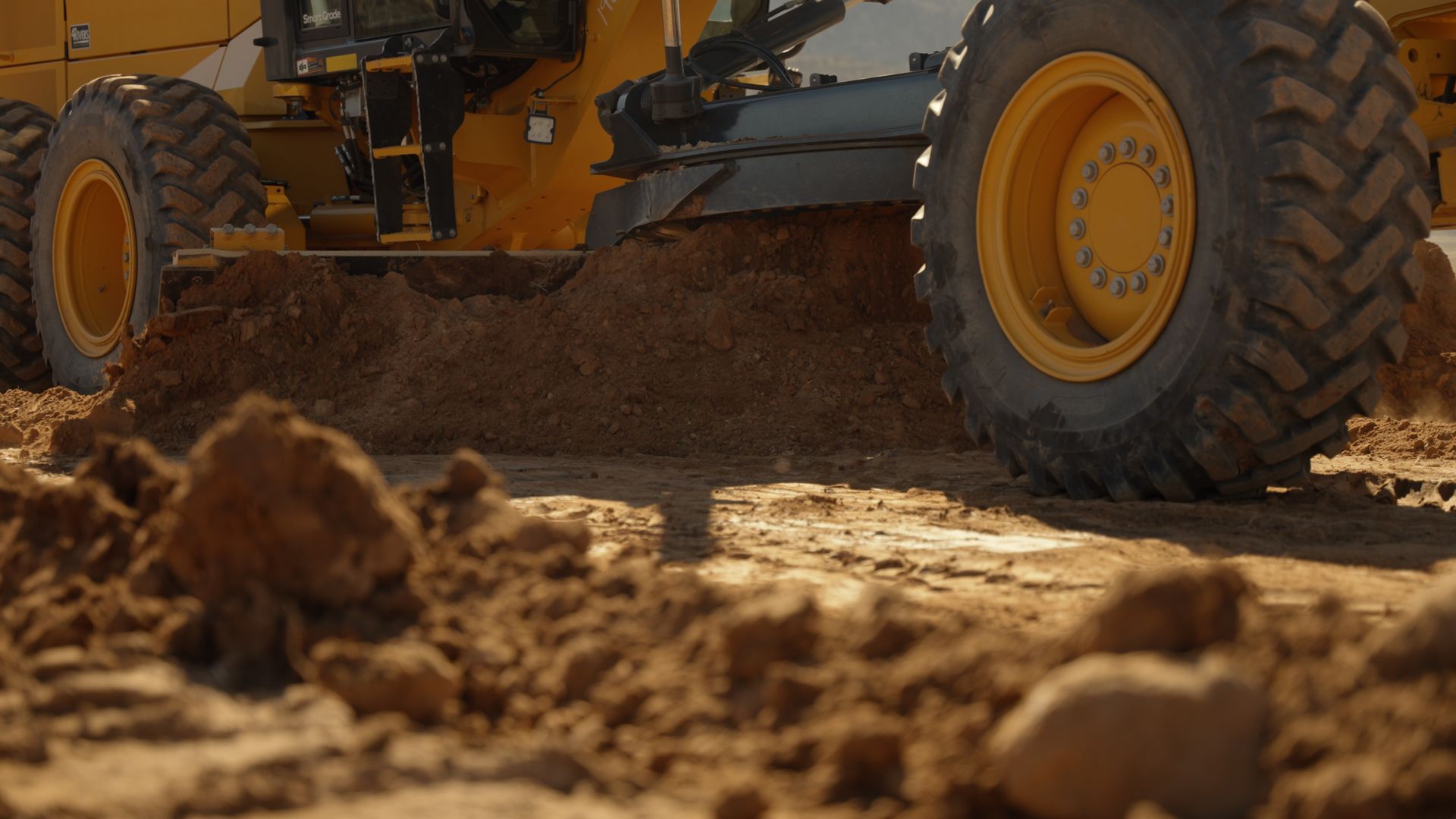 Bulldozer tires rolling over dirt at a construction site