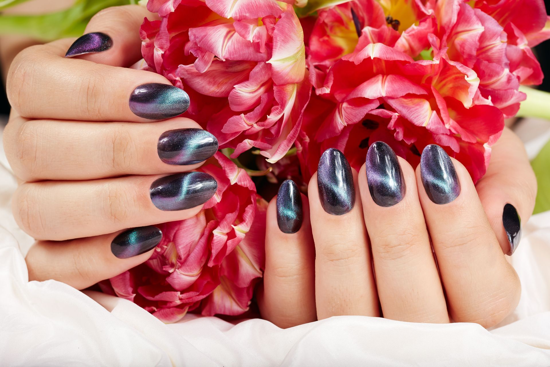 A close up of a woman 's hands holding a bouquet of flowers