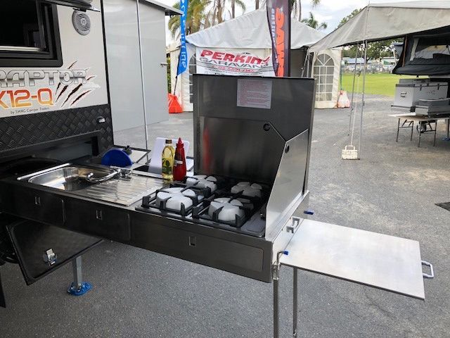 A Stainless Steel Stove Is Sitting On The Side Of A Trailer — Perkins Caravans in Ballina, NSW
