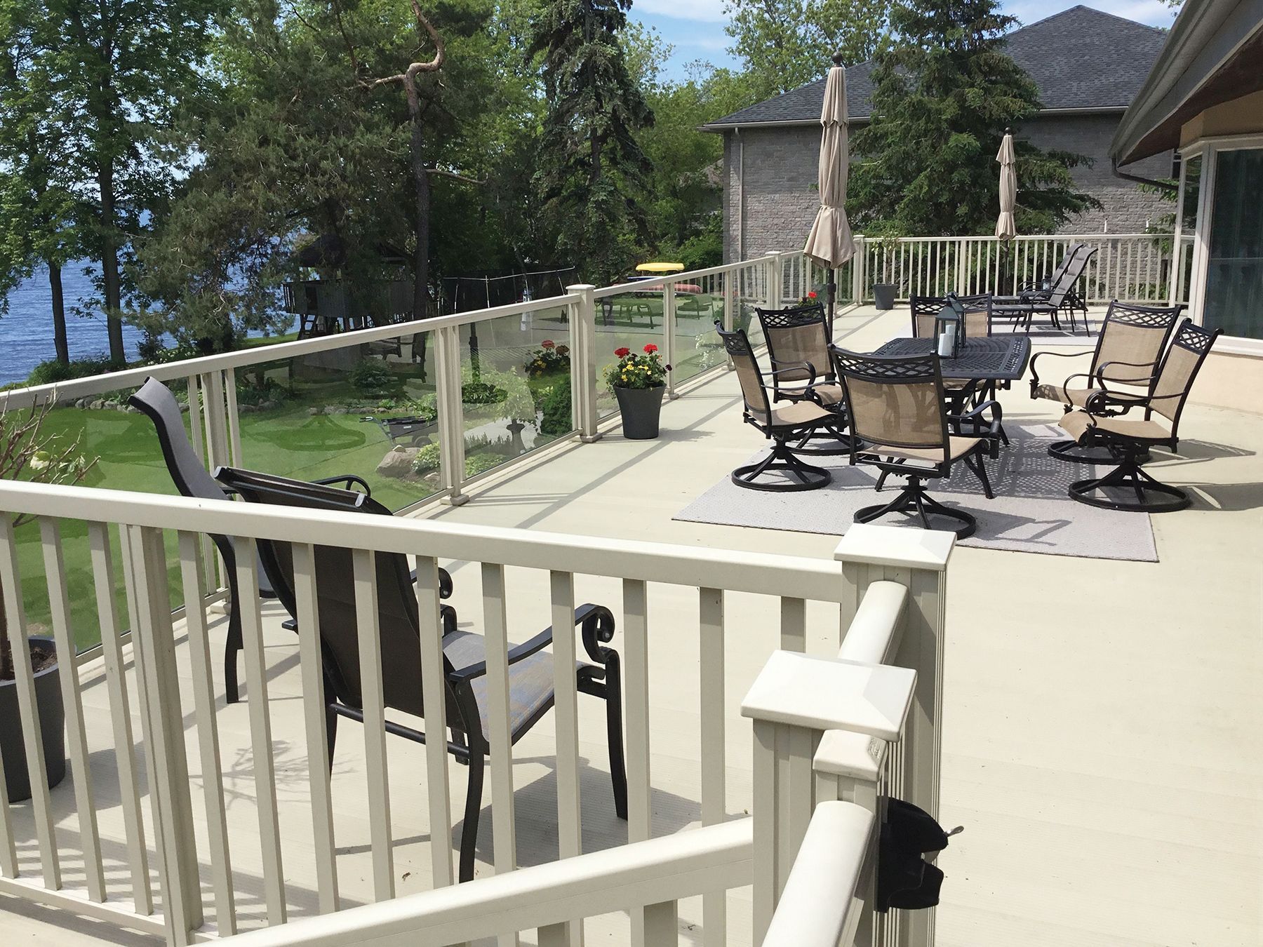 A large deck with a table and chairs on it by Premier Decks & Awnings