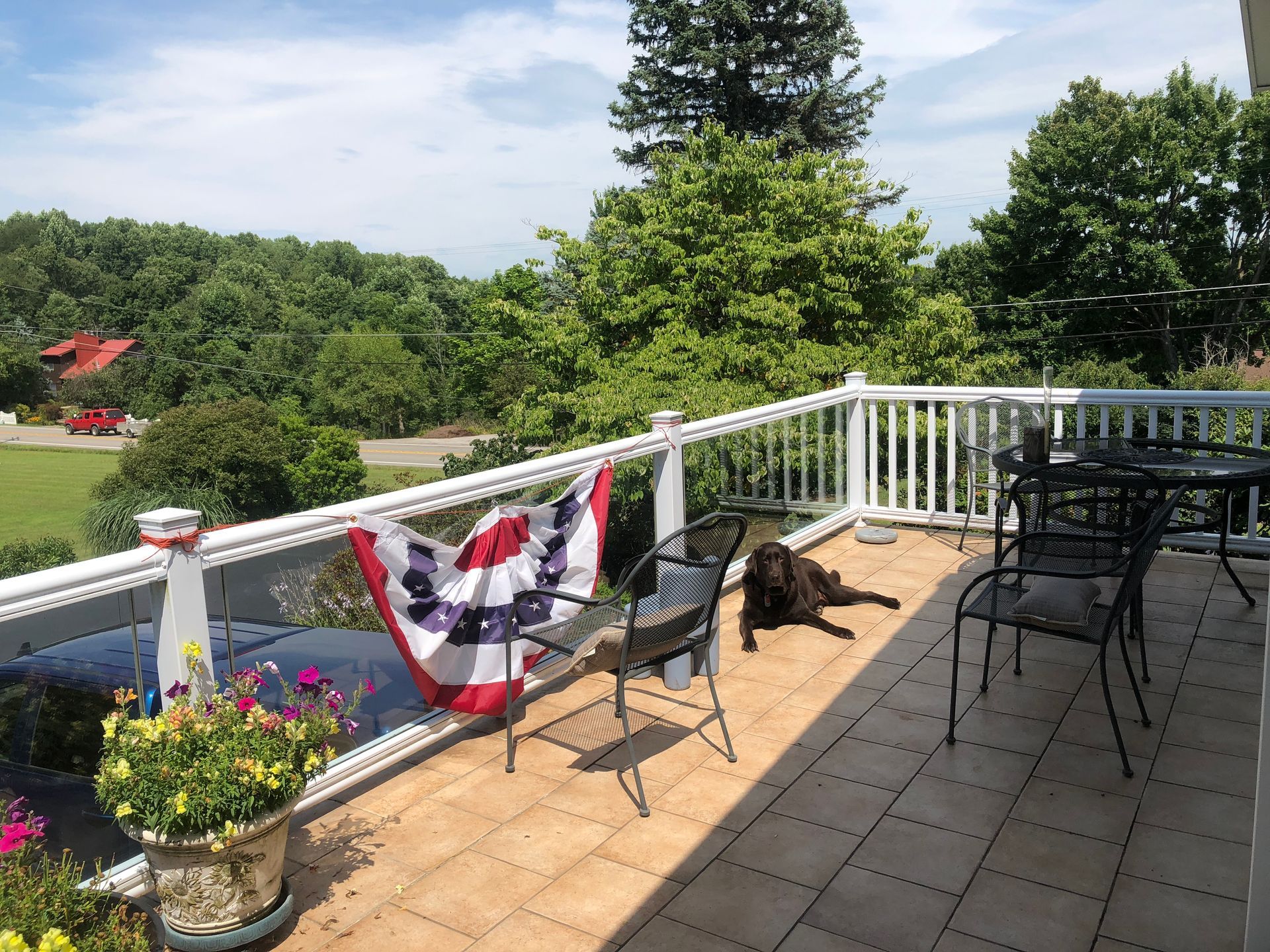 A balcony with a flag hanging from the railing