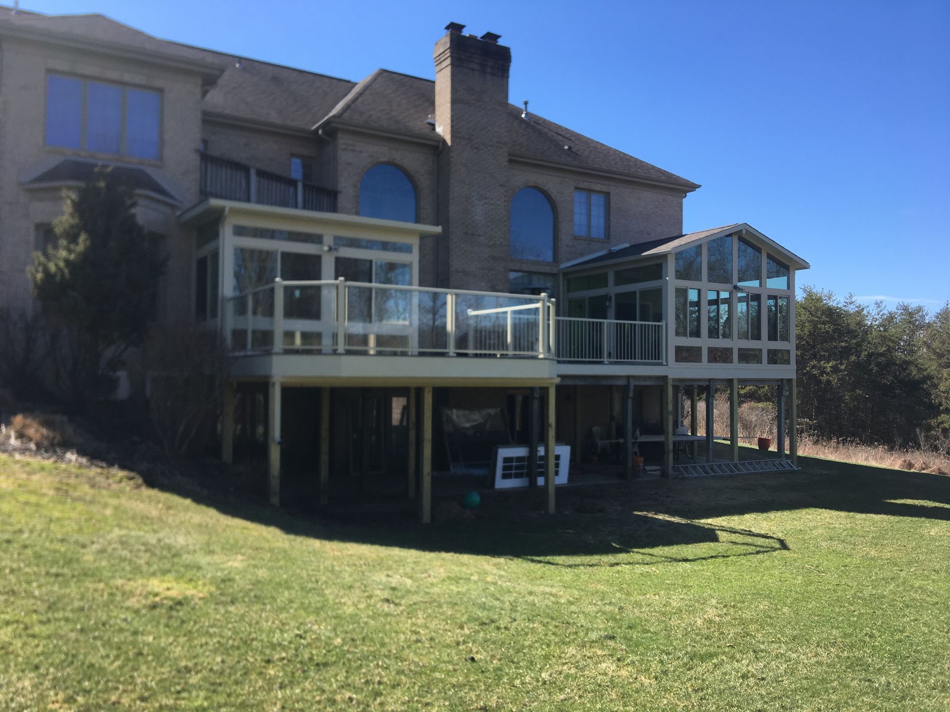 A large house with a large deck in front of it