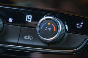 A close up of a car 's a / c control.