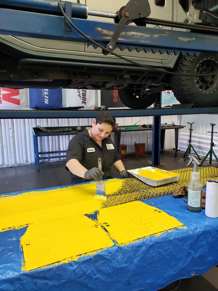 Mechanic Working Under Vehicle On Yellow Mat | Main Street Auto Shop