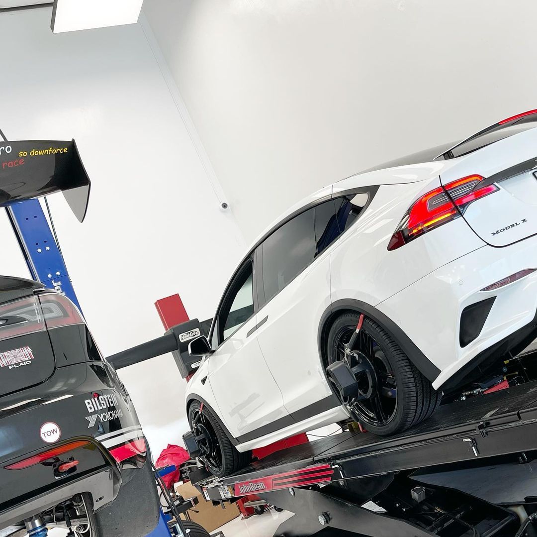 White Sports Car Lifted Inside Auto Shop | Main Street Auto Shop