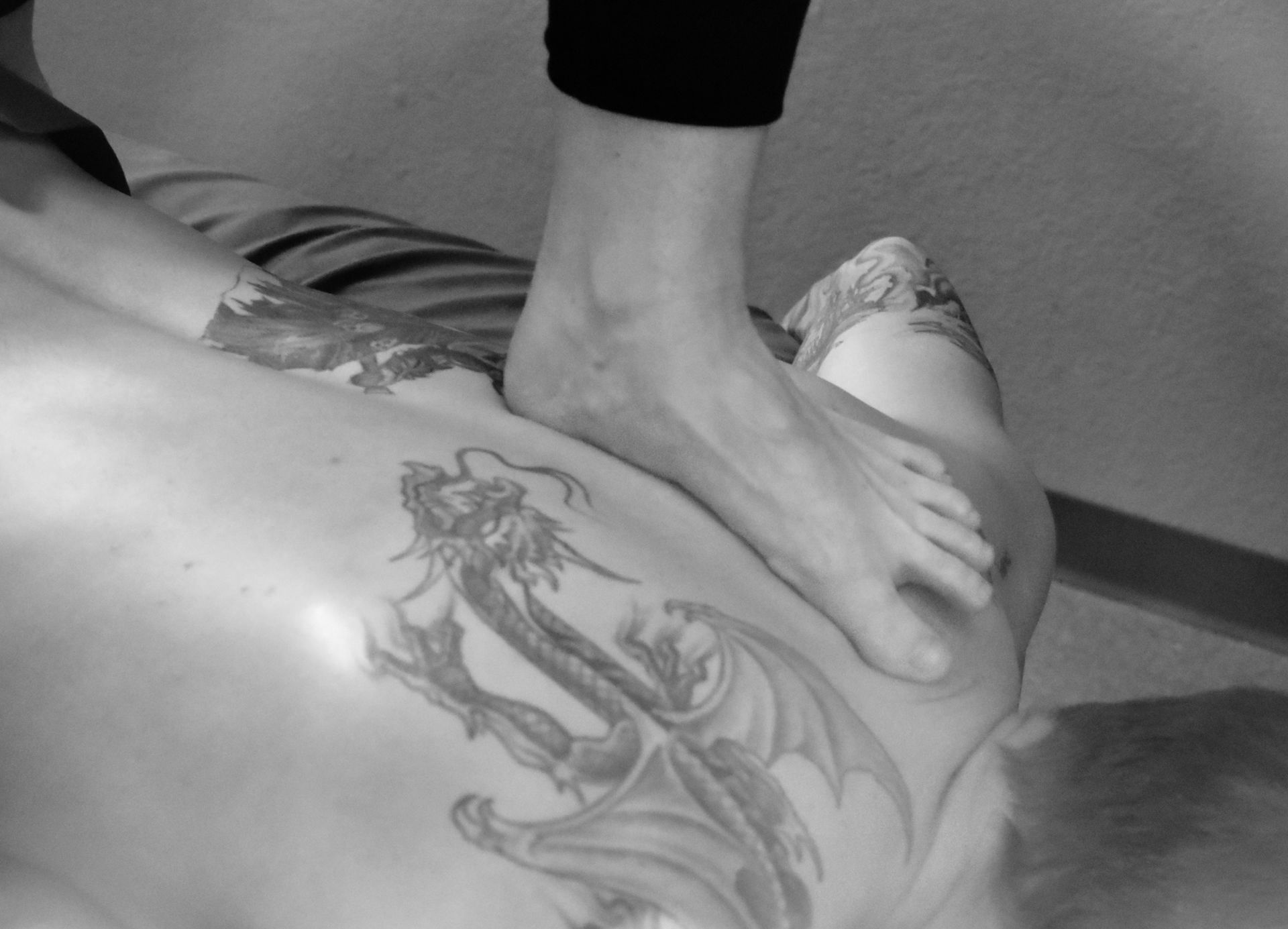 Close-up of therapist applying pressure with their foot during a session