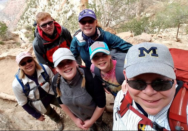 A family selfie with Adam Stewart during a hike