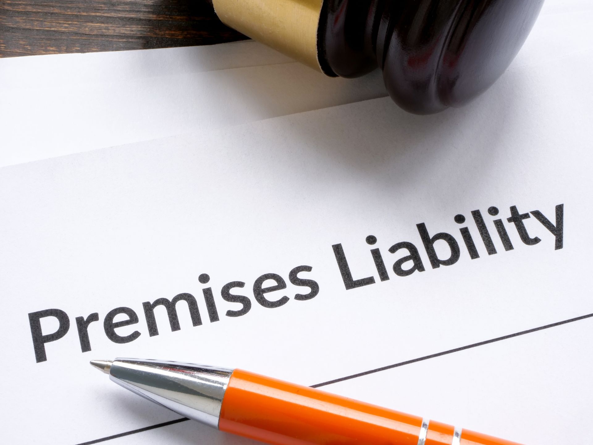 Pen, stamp, and paper with the words “Premises Liability”